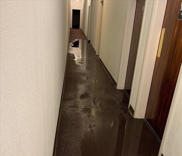 Standing water in a narrow hallway.