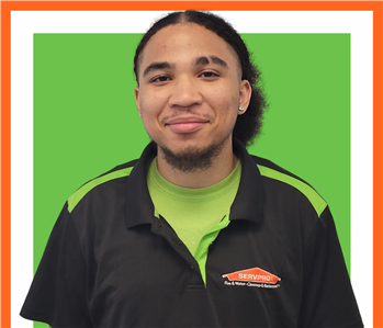Cameron, Male employee with SERVPRO uniform in front of white wall