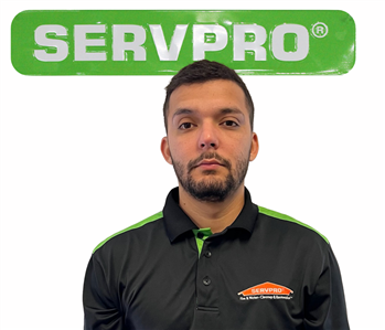 Cesar, male, SERVPRO employee against a white background and green SERVPRO logo